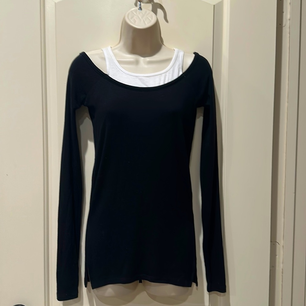 Split 59 off should black ribbed shirt w side slits and tank inset. Size XS.